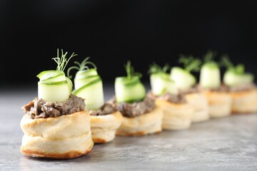 Delicious puff pastry with mushrooms, cucumber and dill on grey table