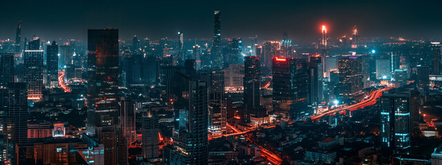 View of a city at night from the top of a skyscraper in the middle of the city.
