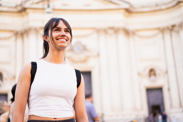 Happy cute tourist girl looking up smiling on vacation in Rome