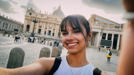 Selfie of a happy girl in front of Saint Peter basilica in Rome on vacation