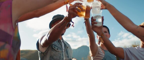 Joyful friends cheering and drinking beers at a festival