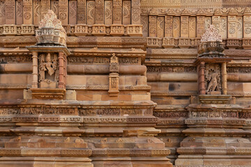 Ancient sculpture remains and intricate designs on the wall of Kandariya Mahadeva Temple in the Khajuraho temple complex, India