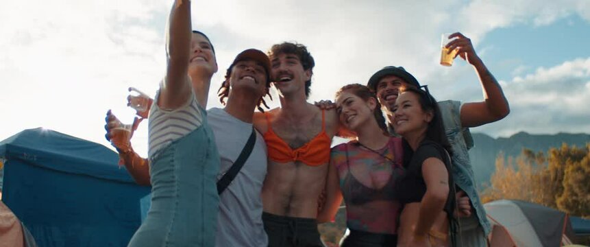 Group of gen z friends taking a selfie at a festival