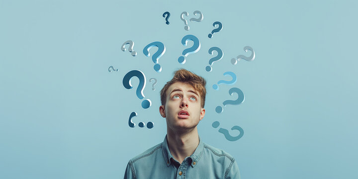 Young man looking up with puzzled expression surrounded by floating question marks, symbolizing confusion and curiosity