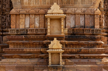 Intricate designs and the missing sculpture in the frames on the wall of Kandariya Mahadeva Temple in the Khajuraho temple complex, India