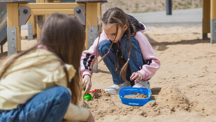 Childs playing sand on playground.