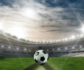 Classic soccer ball on green field in stadium