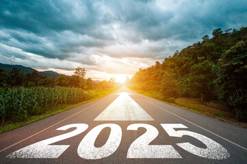 New year 2025 or straight forward concept. Text 2025 written on the road in the middle of asphalt road with at sunset. Concept of planning, goal, challenge, new year resolution.