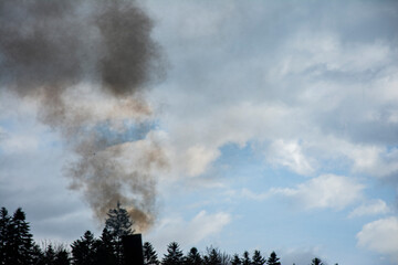 Smoke from chimney and dark clouds on the sky. Factory stack. Pollution of a power plant.