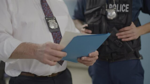 Zoom out from police reading documents