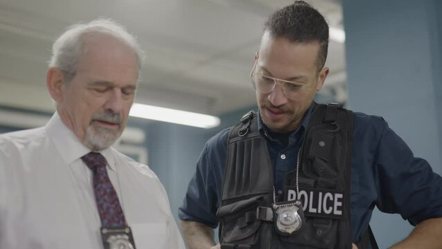 Two cops looking at documents together
