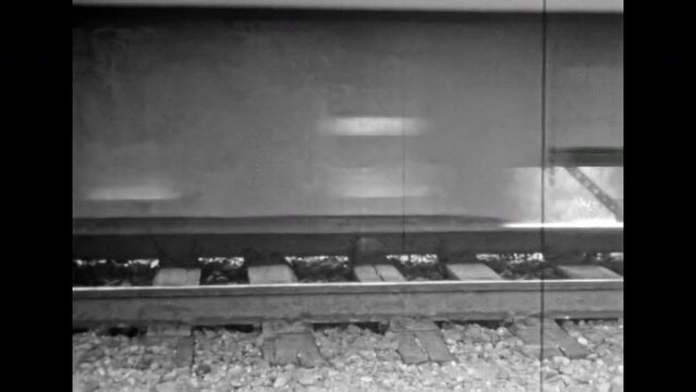 Black white film intercity train, electric train arrives at platform station. Travel by public railroad transport. Electric railway transportation. Subway move high speed. Vintage archive. Retro 1980s