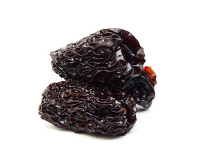 Black dried jujube on white background.