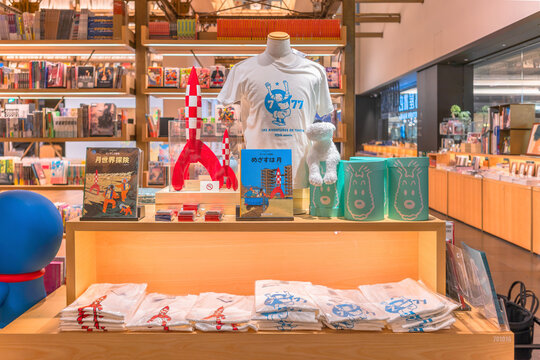 tokyo, ginza - may 17 2024: Japanese bookstore display with comics, t-shirts, merchandises like rocket model from french bande dessin&eacute;e The Adventures of Tintin created by Belgian cartoonist Herg&eacute;.