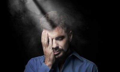Obraz premium despair, young sad man in dark background