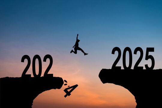 Man jumping on cliff 2025 over the precipice with stones at amazing sunset. New Year's concept. 2024 falls into the abyss. Welcome 2025. People enters the year 2025, creative idea.
