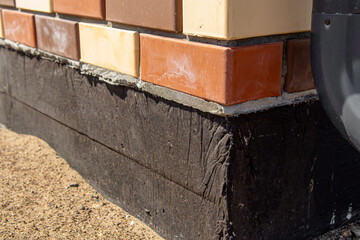 Foundation of country house closeup. Soft focus. Concrete foundation is monolithic slab