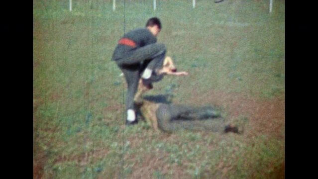 Epic combat technique of Asian martial arts. Practice of disarming protective karate technique. Male karateka repealing sparring partner, opponent attack. Vintage color film. Retro 1980s archive