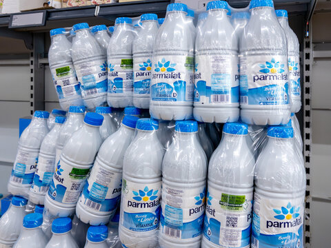Italy - June 01, 2024: Parmalat milk with vitamin D in white plastic bottles packed in shelves for sale in italian discount supermarket