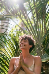 A woman doing yoga outdoors in the shade of palm trees