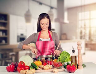 Happy young chef cooking on the kitchen