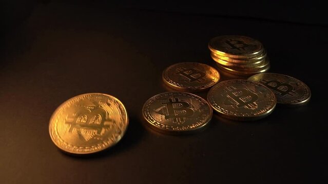 Slow motion bitcoin rolling on dark background