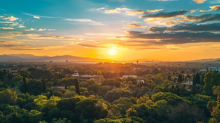 a sunset over a city with mountains in the background