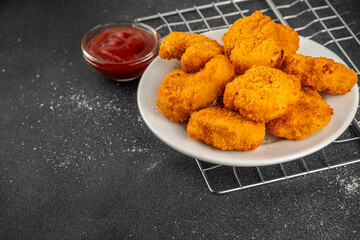 Golden chicken nuggets with ketchup sauce