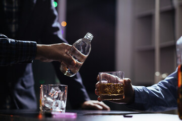 Businessmen and investors drink alcohol together in office after discussing their joint venture plans to conclusion. backdrop of alcoholic celebrations between investors and successful businessmen.