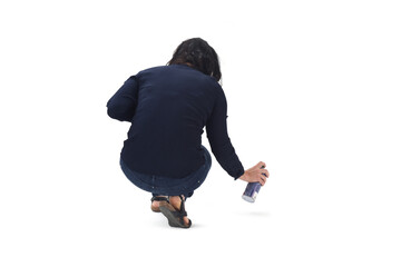 rear view of a woman painting on the floor with spray on white background