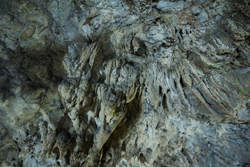 Rock formations and abstract texture on the walls in Muierilor Cave with stalactites and stalagmites