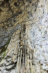 Rock formations and abstract texture on the walls in Muierilor Cave with stalactites and stalagmites