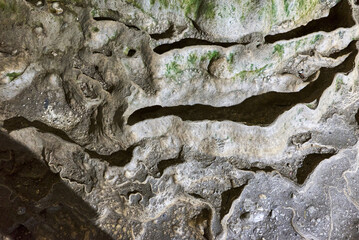 Rock formations and abstract texture on the walls in Muierilor Cave with stalactites and stalagmites