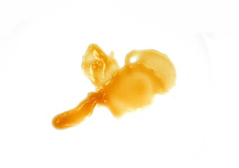 Baby fruit puree spilled on white background. Baby fruit puddle isolated.
