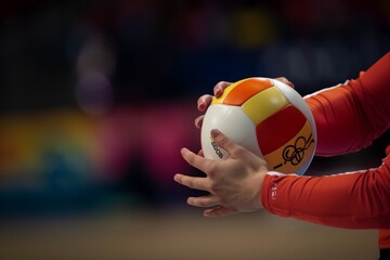 Volleyball Player Preparing to Serve the Ball with Olympic Logo Visible on Uniform