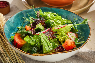 Fresh Vegan Vegetable Salad with Greens and Tomatoes in a Rustic Bowl
