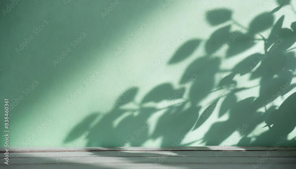 Poster light background of shadows from plant leaves on a delicate light green lime wall, minimalistic back