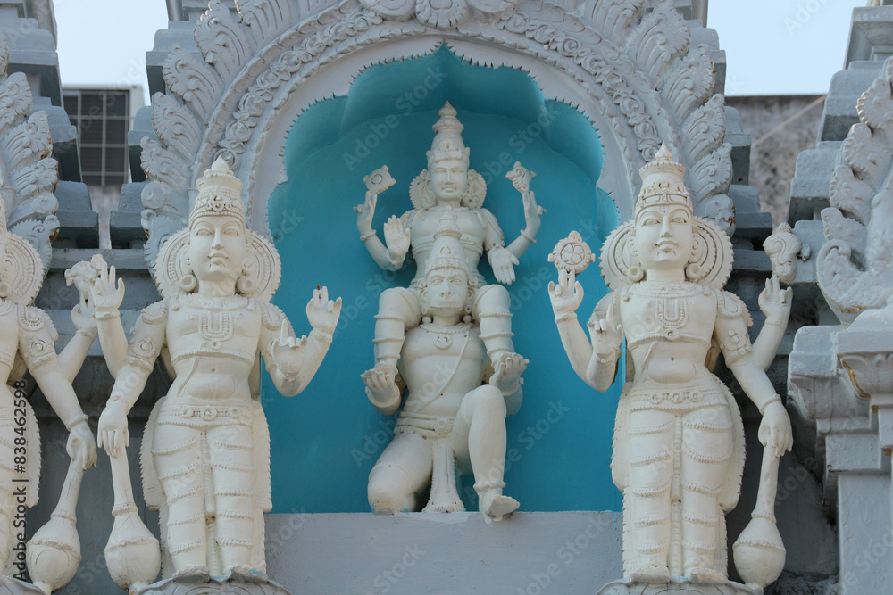 Wall mural Lord Vishnu riding Hanuman. Bas-relief on a Hindu temple in India.