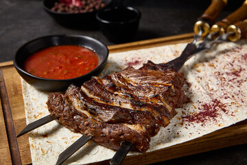 Grilled Lamb Breast and Skewered Lamb Kebab on Flatbread with Tomato Sauce