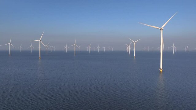 Wind Turbines park in the Lake IJsselmeer in Flevoland Netherlands, Offshore Windmill Windmill Farm in the Sea, Sunset