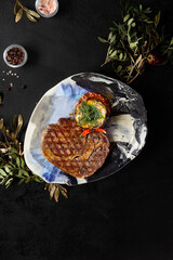 Elegant Dining Experience: Ribeye Steak with Roasted Potatoes on a Chic Plate