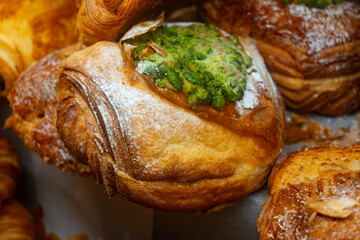Fresh baked pastries for breakfast, pistachio croissant with cream filling