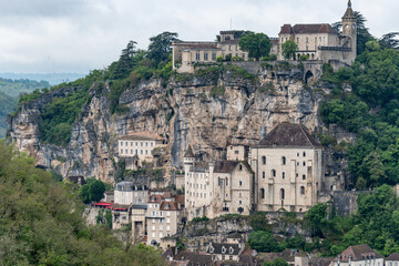 Fototapeta premium Rocamadour medieval village located on pilgrims route in Lot department in southwestern France, attracted visitors for its setting in gorge above tributary of River Dordogne, panoramic view