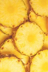 Pineapple juicy yellow slices background. Top view.