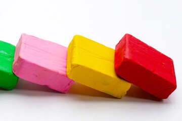 Colorful plasticine clay on white background.