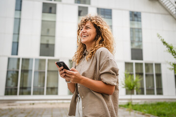 Portrait of adult woman stand in front business build use mobile phone