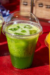 Colorful fresh pressed fruit green kiwi juice with fresh fruits and berries