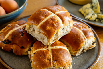 Traditional British Easter food, fresh baked cross buns with raisins or apples