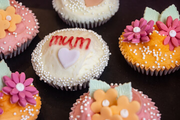Colorful marzipan almongs cakes with decorative marzipan flowers