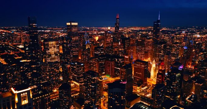 Dazzling illumination of modern American metropolis at night. Scenic view of Chicago, Illinois, United States from top.